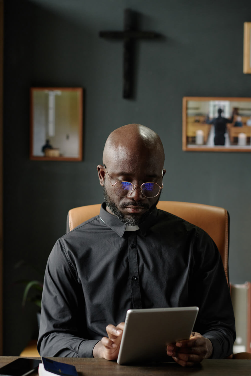 Pastor studying on a tablet